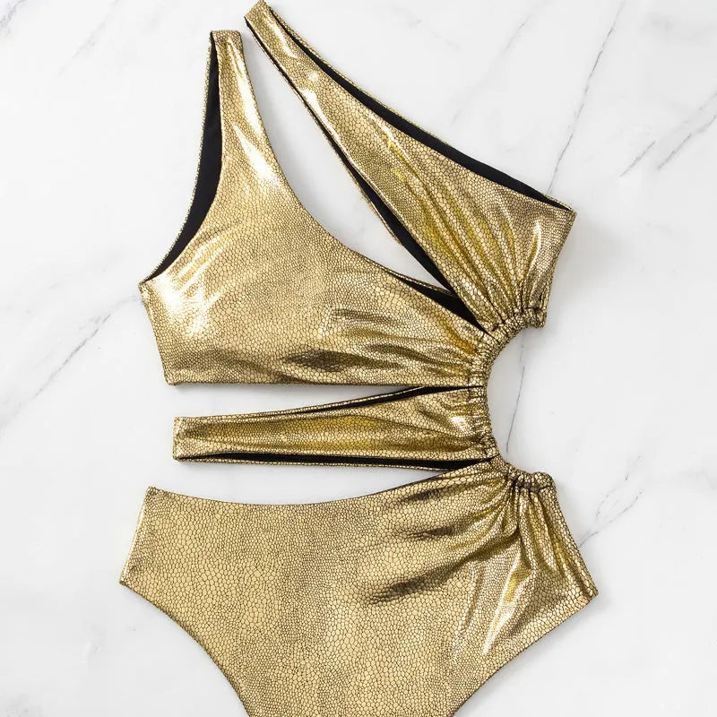 Gold coloured backless one-piece swimsuit for women on a white background.