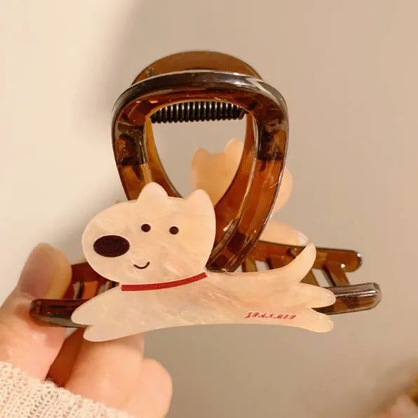 Beige and brown cartoon puppy hair grip barrettes on white background