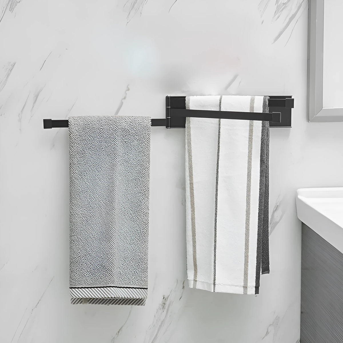 Black folding towel bar mounted on a bathroom wall with no visible screws or drill holes.