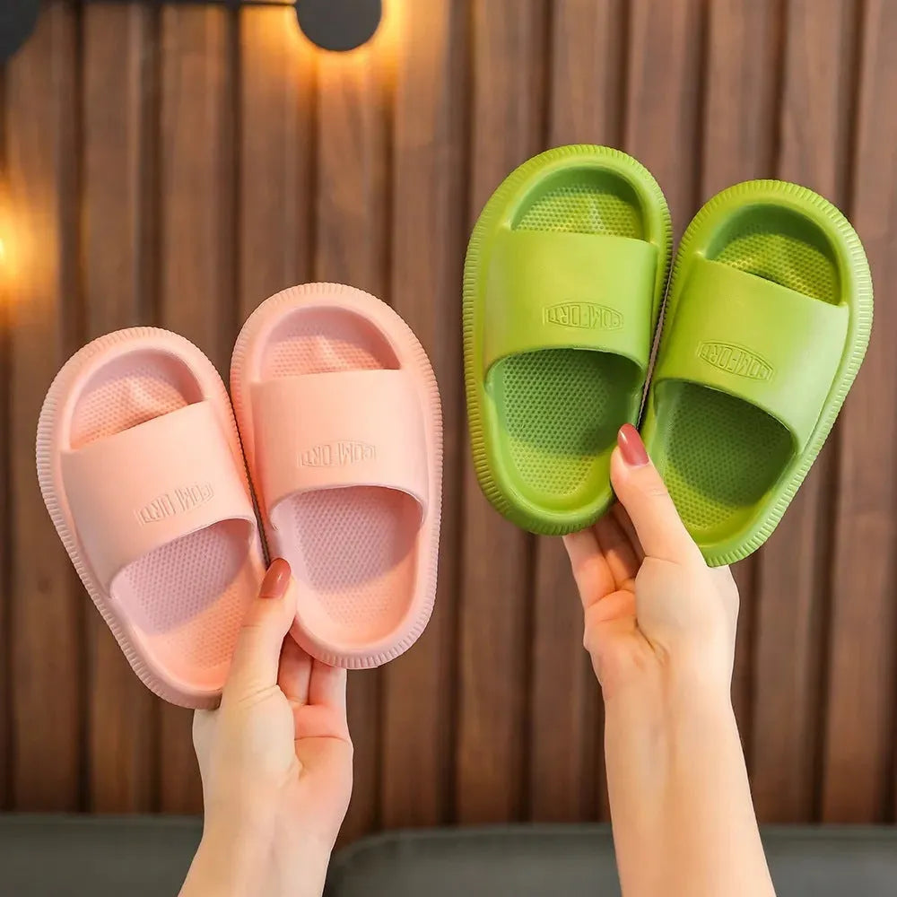 Children's bright coloured EVA slippers with textured non-slip soles, shown in blue, green, orange, pink, and yellow.