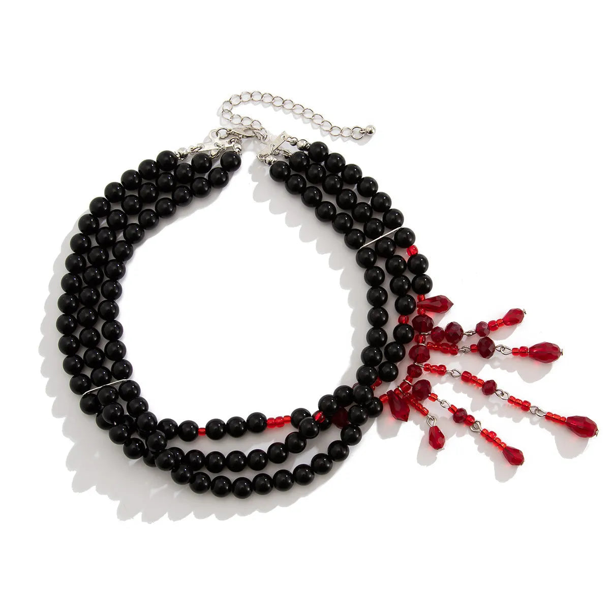 Men's Halloween necklace with red artificial crystal blood drop pendant and black imitation pearl tassels on a metal chain.