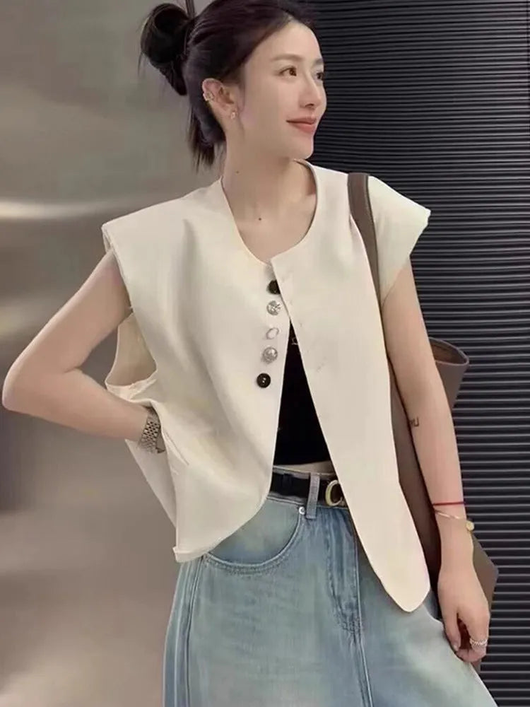 Women's short-length polyester vest in milky white, showing loose fit and front pockets