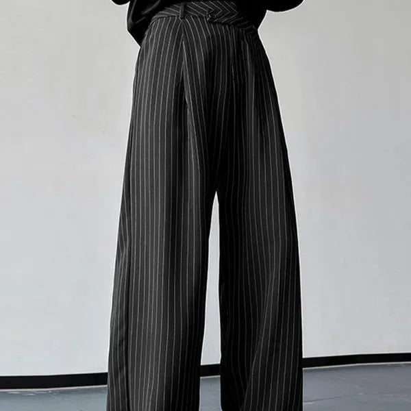 Men's black vertical striped pleated casual trousers with elastic waistband showing front detail
