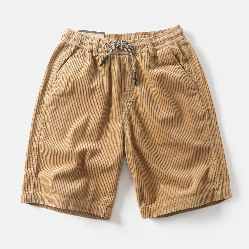 Men's khaki retro cargo shorts with a straight leg on a summer streetwear backdrop.