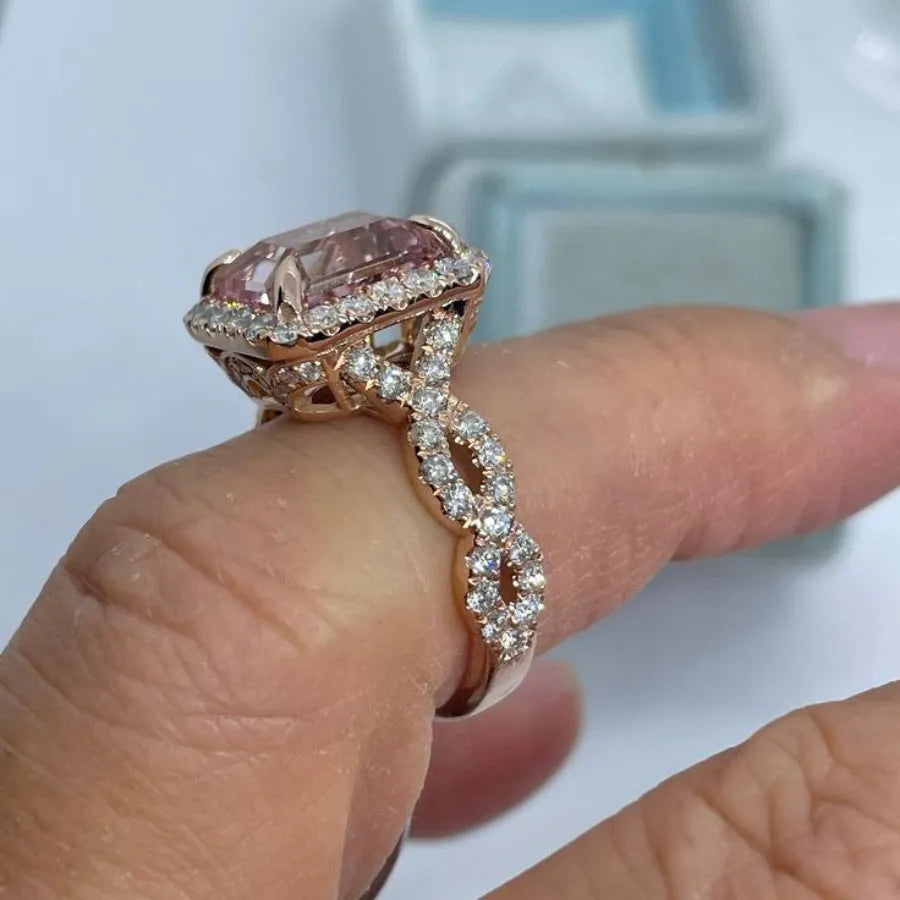Geometric design rose gold alloy ring on a grey background, showing its clean lines and metallic finish.