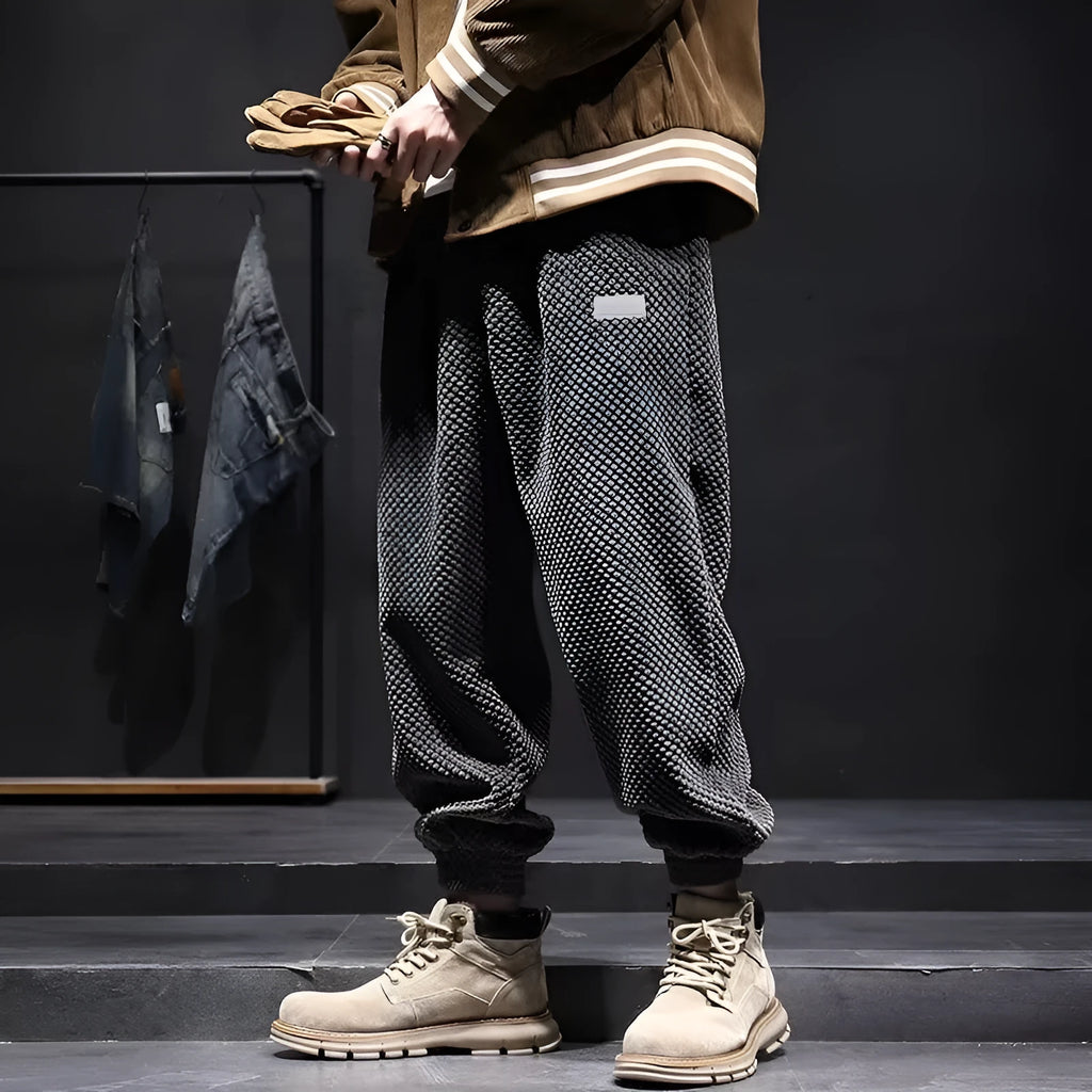 Men's grey ankle-tied straight-leg sweatpants laid flat, showing non-ironing polyester blend fabric.