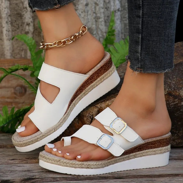 White patent leather wedge sandals with peep toe woven design and finger fit construction