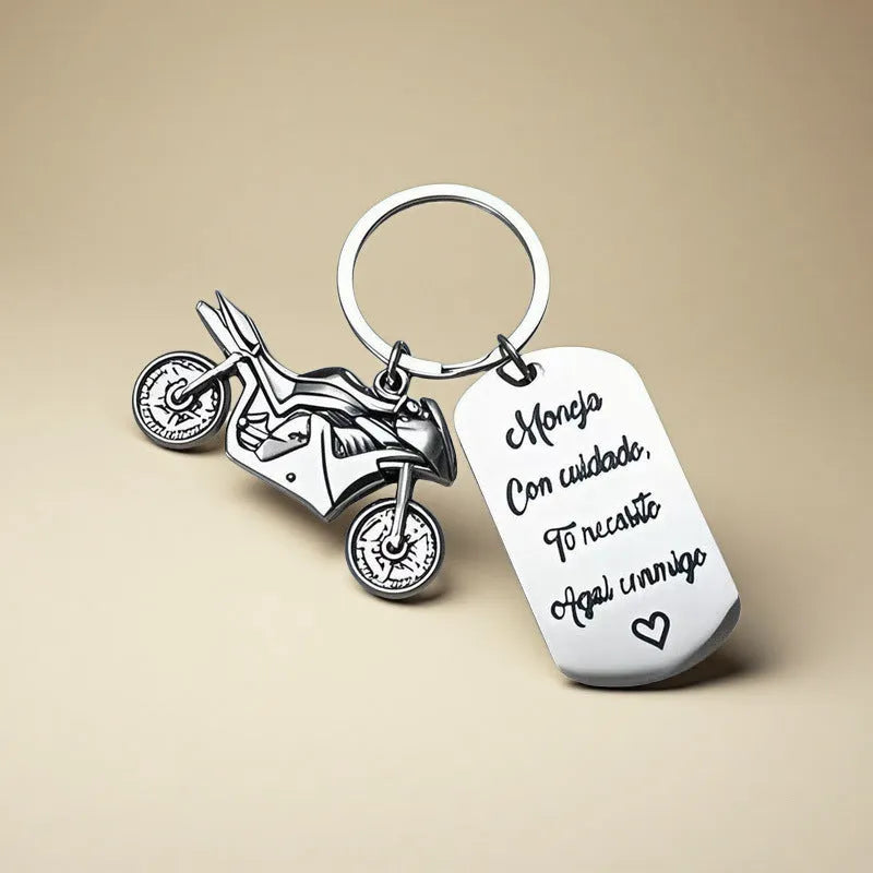 Stainless steel motorcycle key chain with charm and grey flannel storage bag.