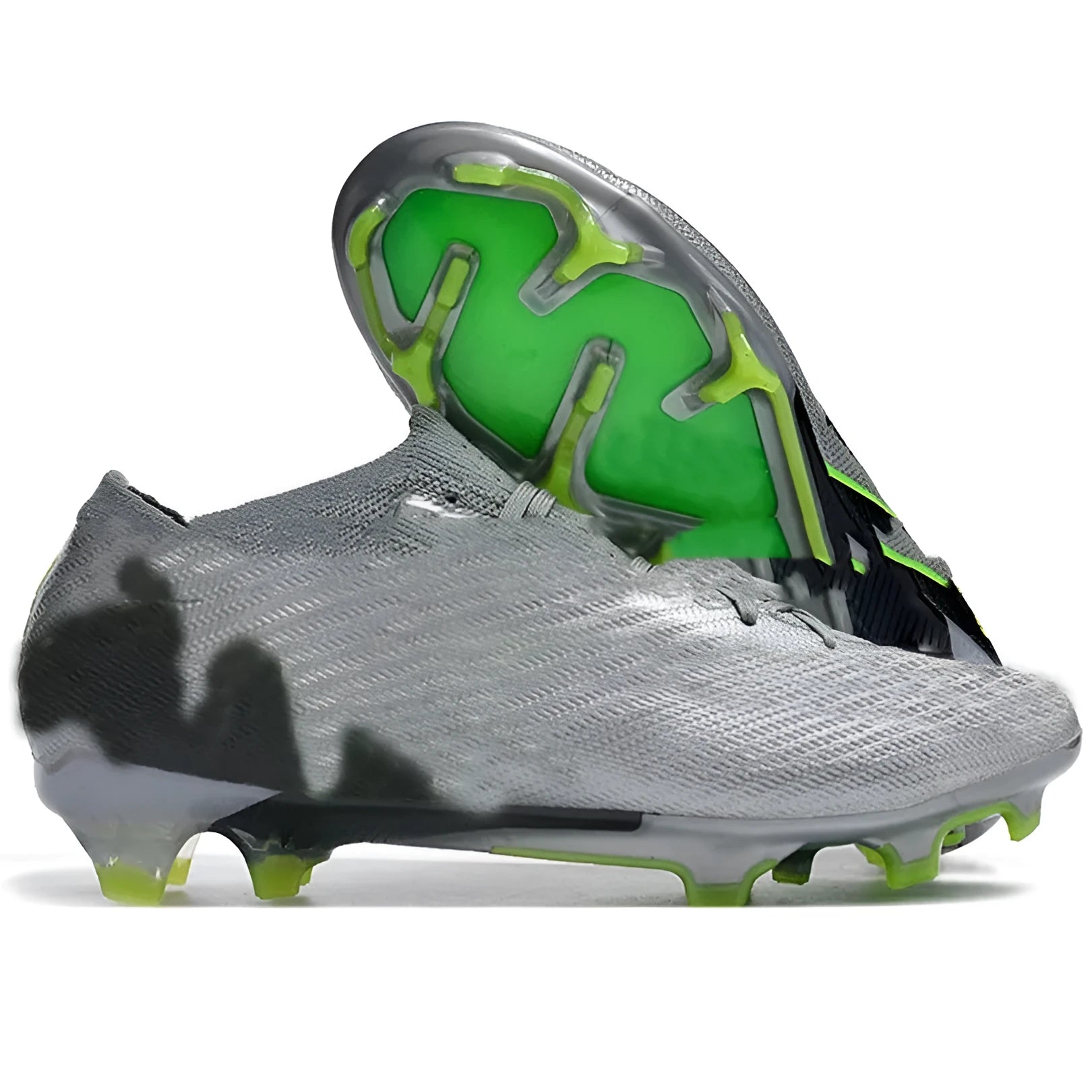 Men's low-top knitted football shoes with white sole and black upper, showing FG studs.