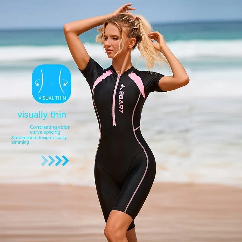 Solid colour women's one-piece surfing swimsuit with short sleeves and a built-in chest pad.
