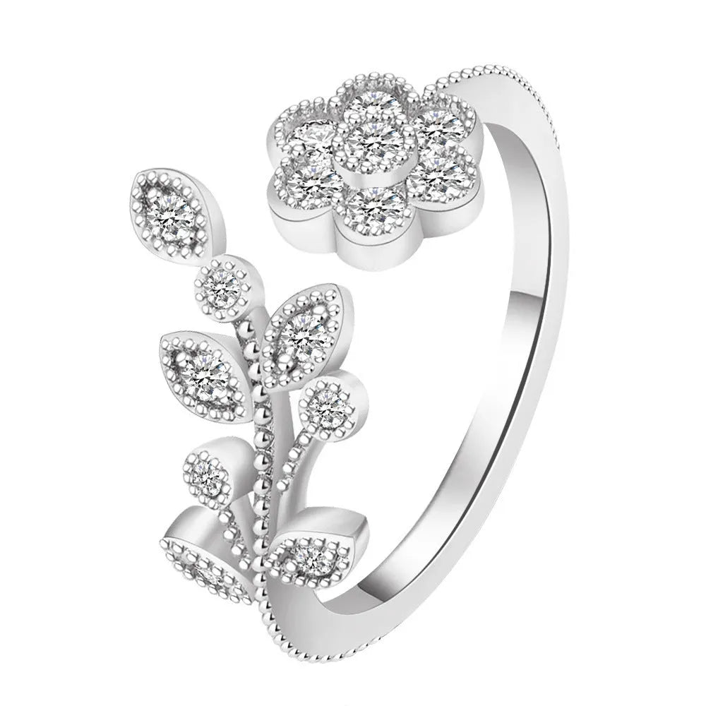Women's open ring with diamond-treated flower and leaf design in gold colour on copper base