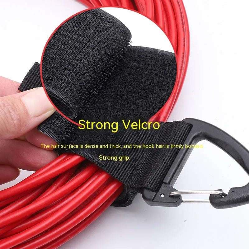 Black heavy-duty gravity storage strap with metal carabiner hook for garages and outdoor travel