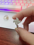 Rotating geometric windmill ring in gold or silver finish on a copper band.