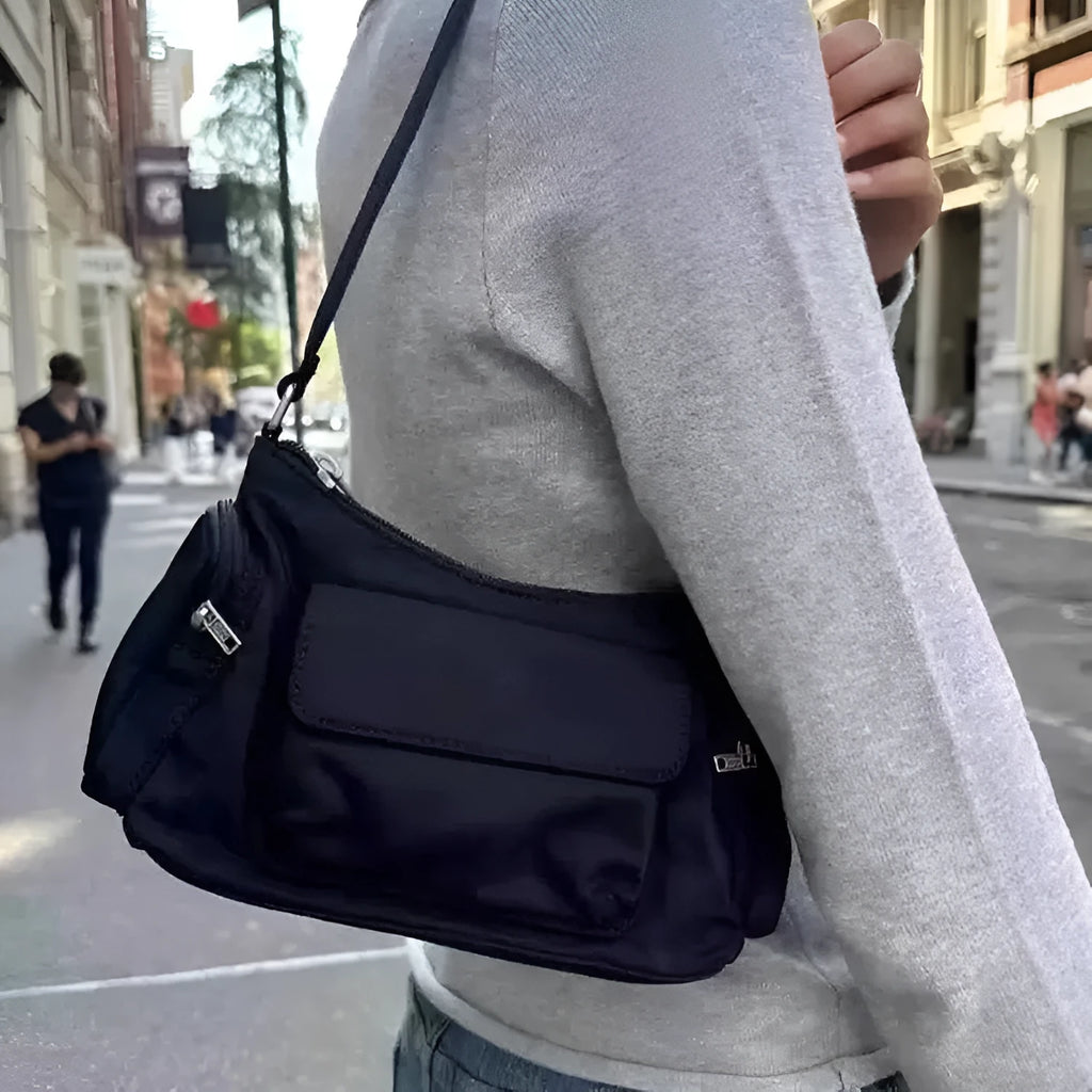 Black double pocket shoulder bag with side line detailing showing interior organisation