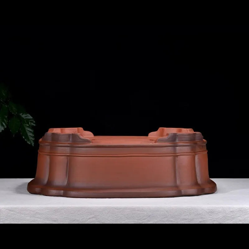 Large antique-finish Chinese purple clay flower pot with decorative tree stump and floral motifs.
