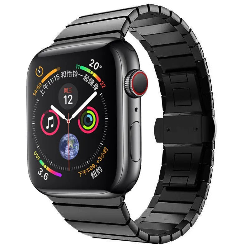 Silver stainless steel Apple Watch strap with butterfly buckle on a wrist.