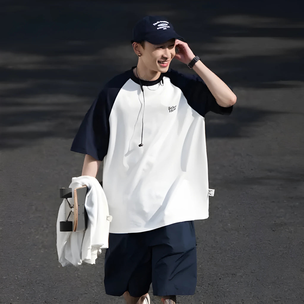 Men's blue loose-fit casual t-shirt with raglan sleeves on a hanger.