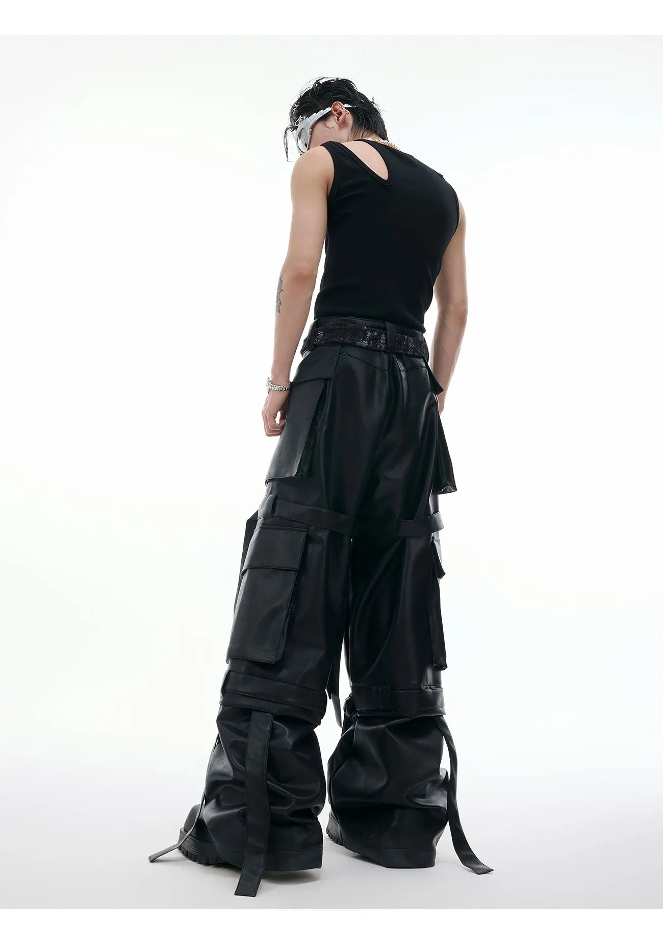 Black loose-fit retro trousers with quilted stitching pattern, multiple pockets, and ribbon trim detail.