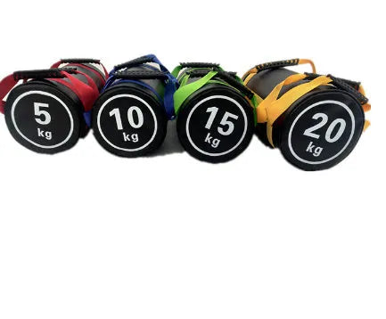 Flat white leather PVC fitness training sandbag shown in a gym setting for weight lifting and conditioning.