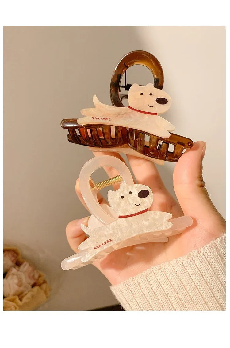 Beige and brown cartoon puppy hair grip barrettes on white background