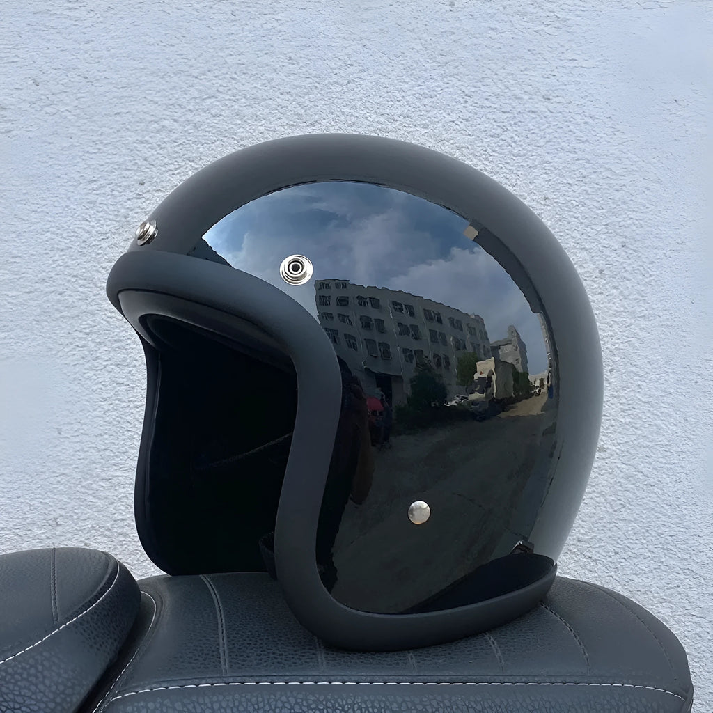 Retro-style half-shell motorcycle helmet in fibreglass, shown in a cement grey colour option.