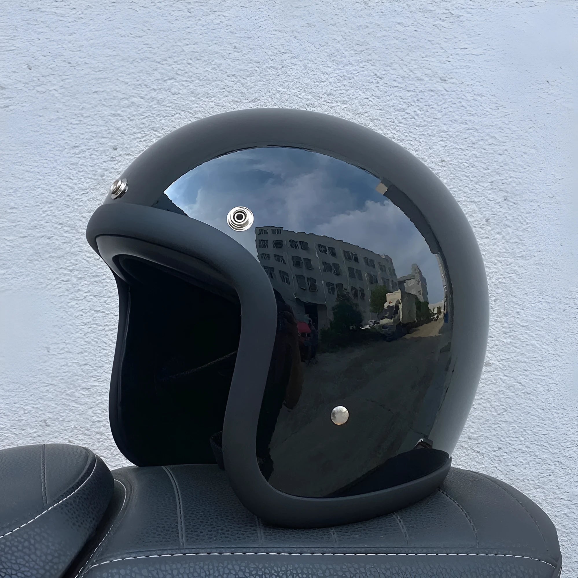 Retro-style half-shell motorcycle helmet in fibreglass, shown in a cement grey colour option.