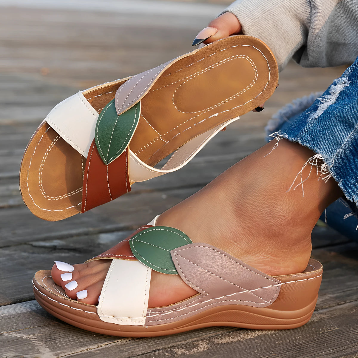 Women's black peep-toe slipper with a cross-strap and thick sole on a white background.