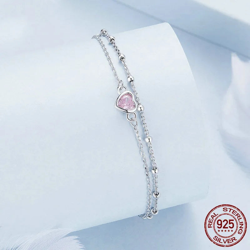 Women's 925 sterling silver bracelet with small heart-shaped pendant on an adjustable chain.