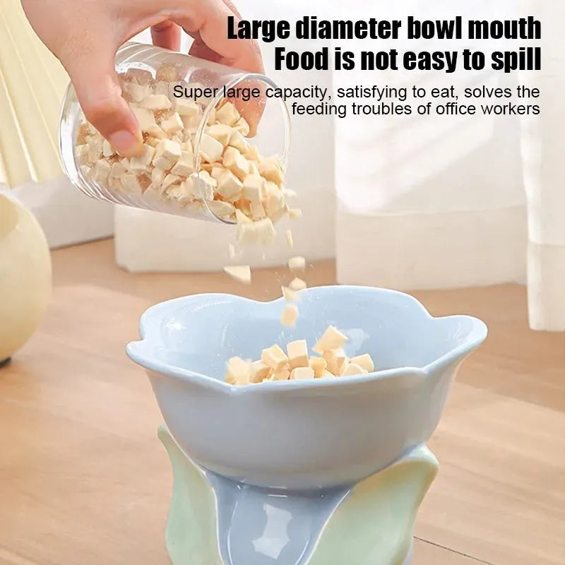 Blue ceramic elevated pet bowl with floral pattern and non-slip base for cats and small dogs.