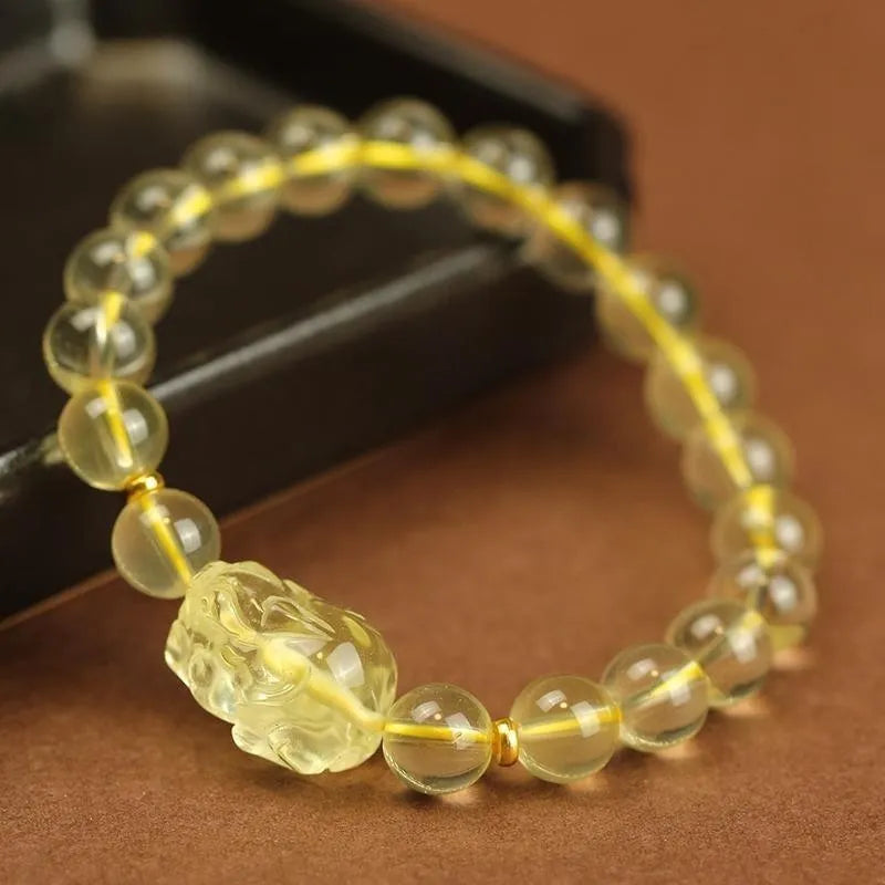 Yellow leather bracelet with an artificial citrine Pi Xiu charm in simple Chinese style.