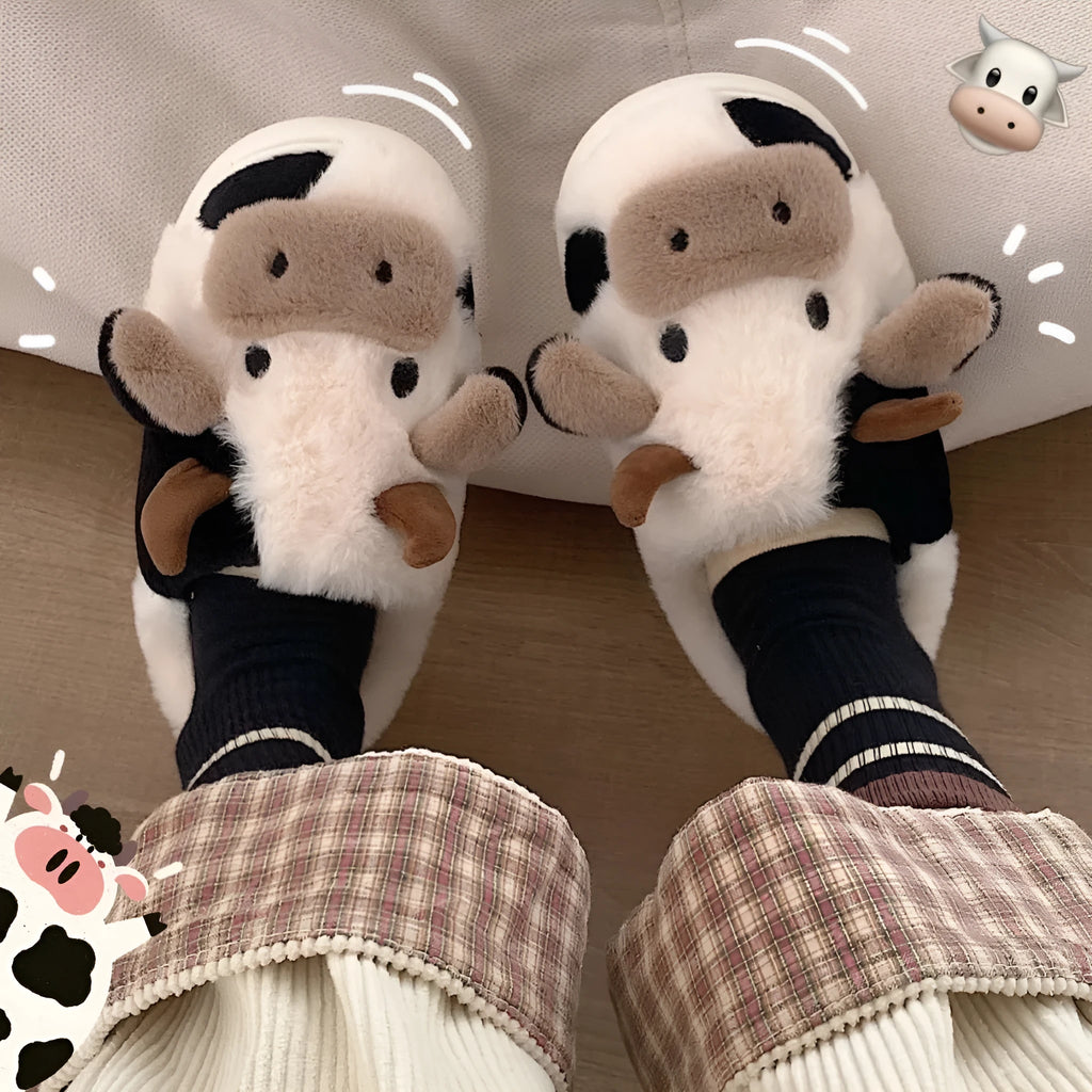 White plush cow slippers for women with black spots, a smiling face, and a textured non-slip sole.