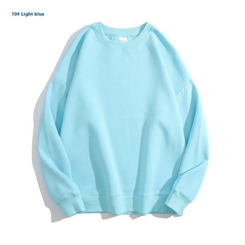 A loose-fitting, light blue off shoulder sweater with long sleeves and a round neck, made from cotton.
