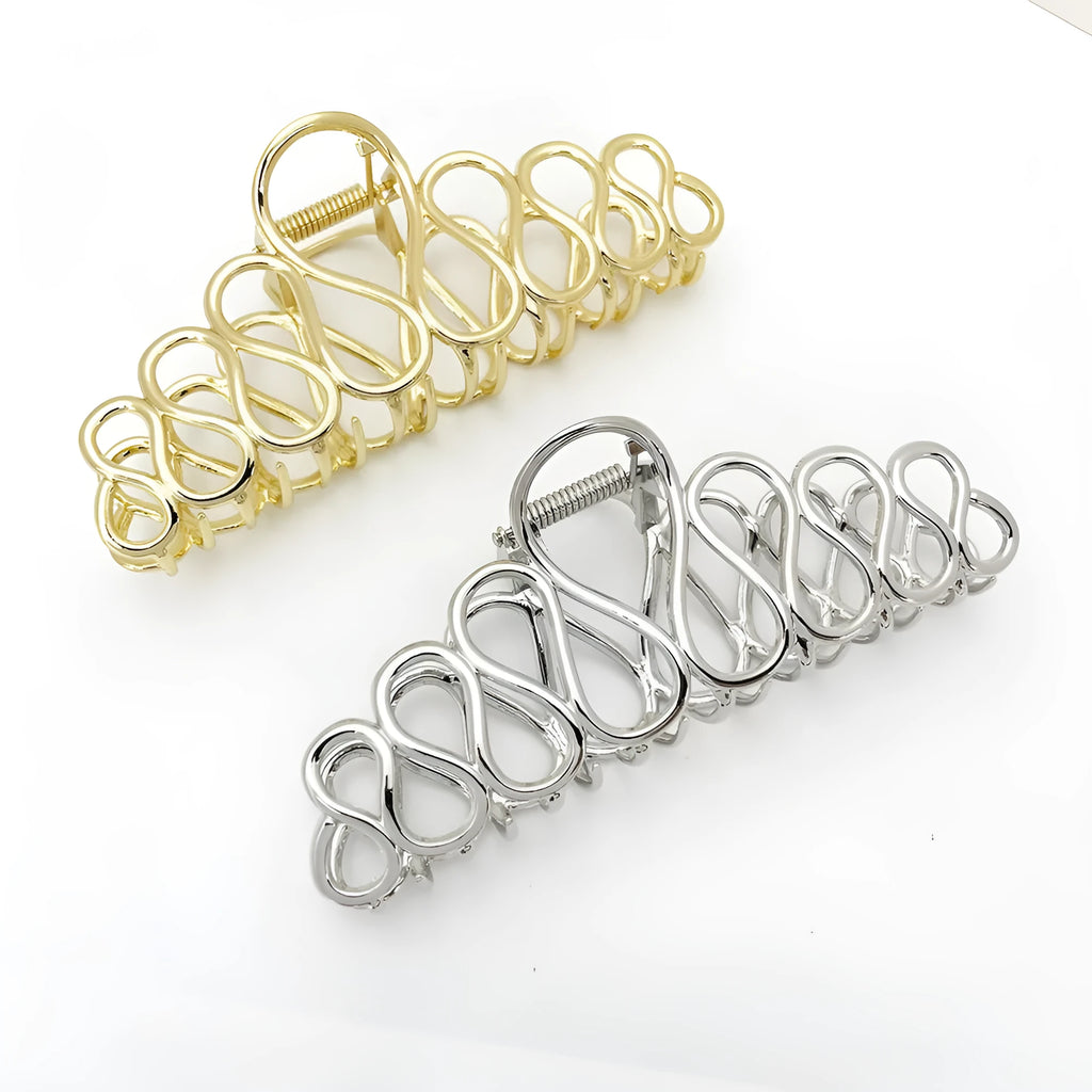 Large minimalist updo hair clip with tassel detail in gold or silver electroplated finish.