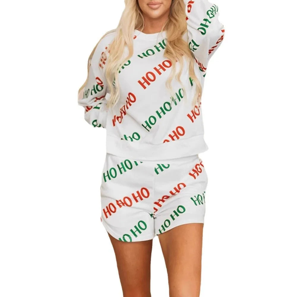 Women's white two-piece suit with letters printed design showing long-sleeved top and trousers