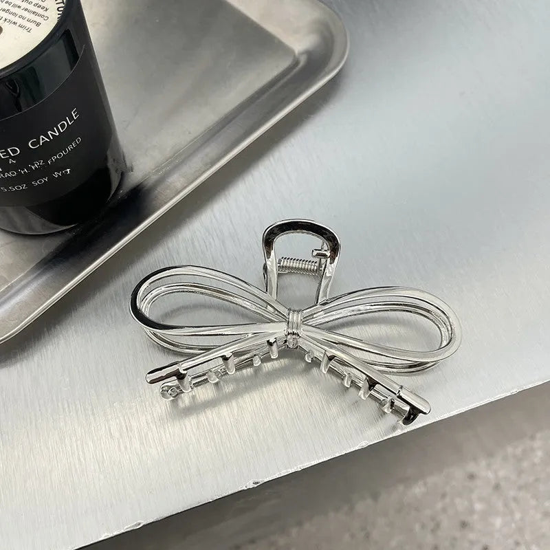 Alloy metal bow hair clip for women in silver or gold colour, Korean style.