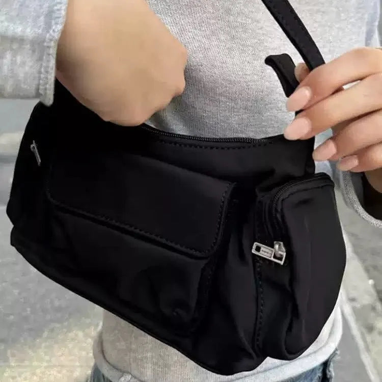 Black double pocket shoulder bag with side line detailing showing interior organisation