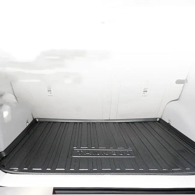 Black TPE car boot liner with a carbon fibre pattern texture, laid flat.