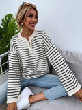 Black striped women's casual top with drop-shoulder sleeves and button detail