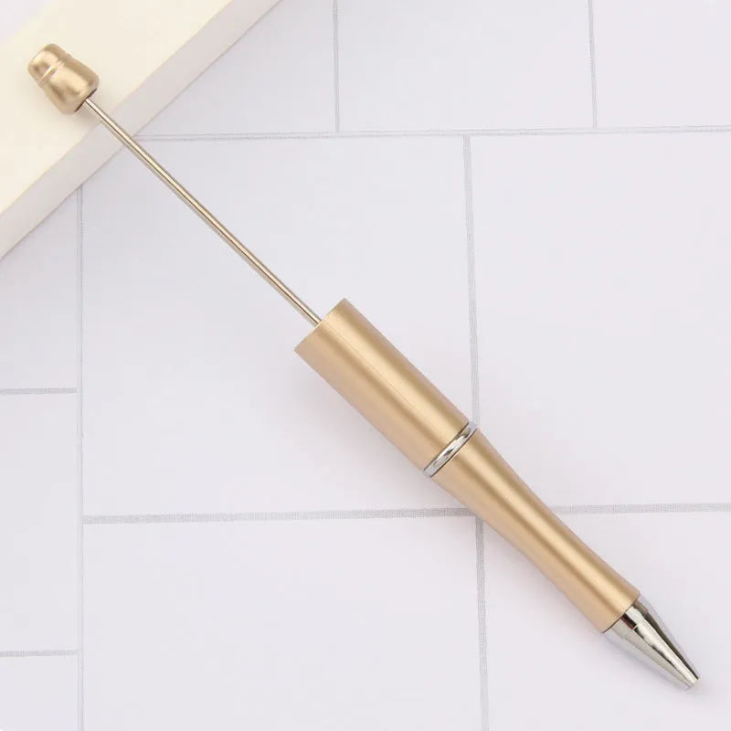 Ballpoint pen with colourful spinning plastic beads on barrel, shown in a gradient purple finish.
