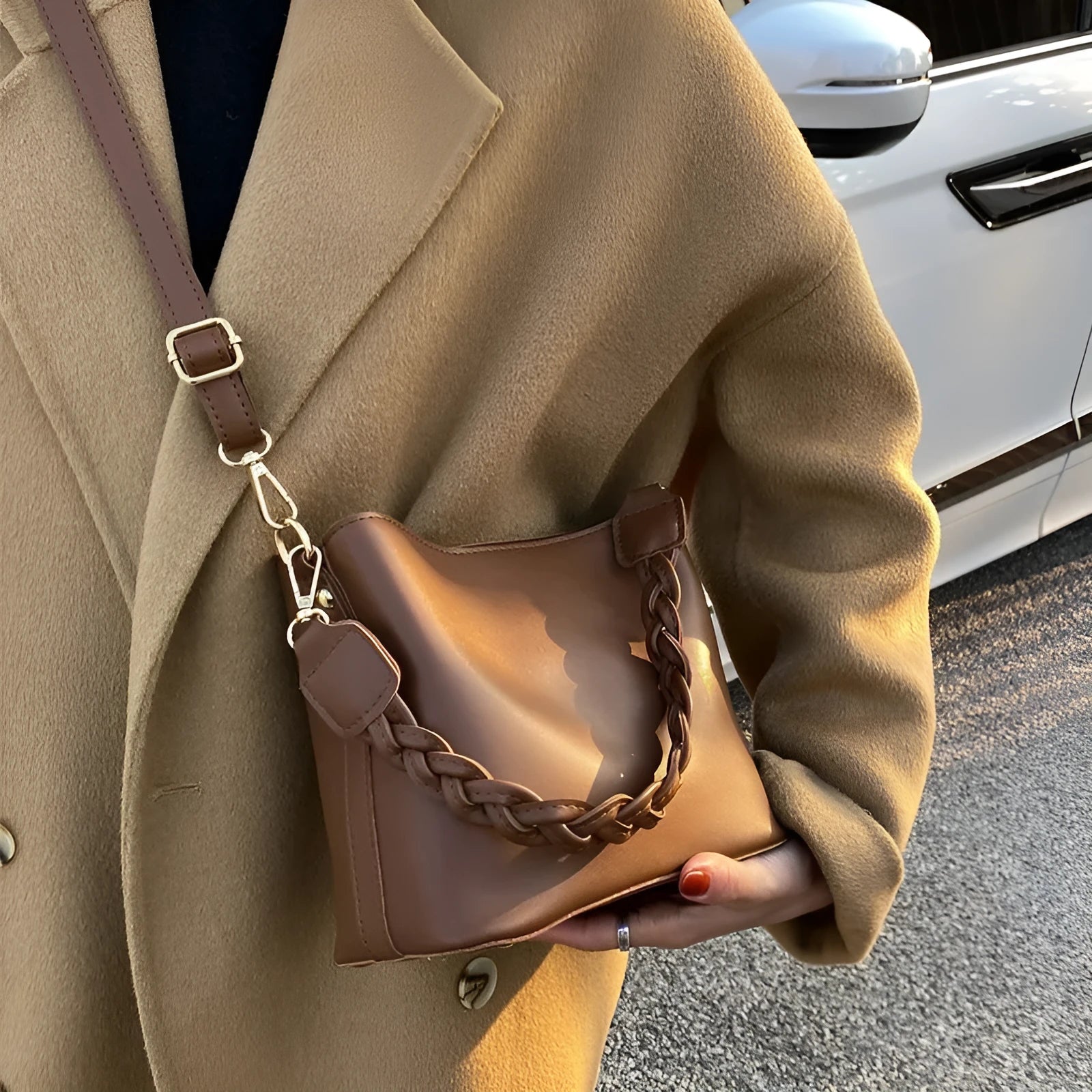 Khaki PU woven one-shoulder crossbody bucket bag with retro design on a mannequin