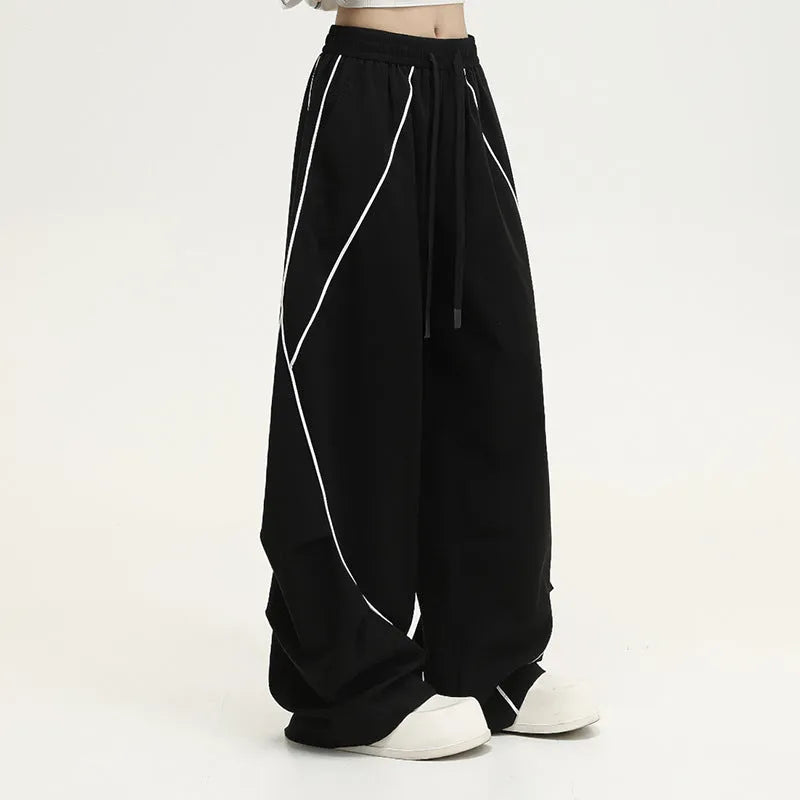Black pleated wide-leg hip hop pants with striped pattern and mid-waist design made of polyester