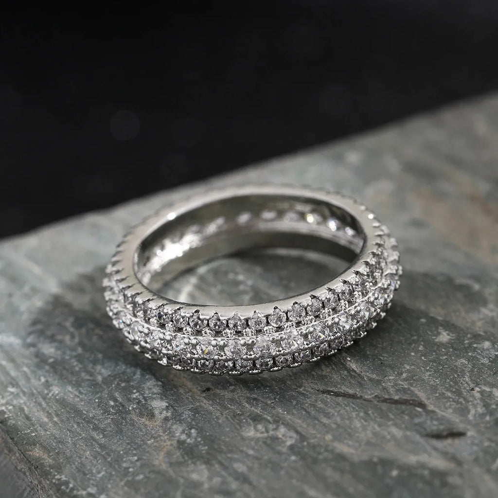 Geometric copper ring with a triangular zircon stone inlay, shown in white gold, yellow gold, and white and black plated finishes.