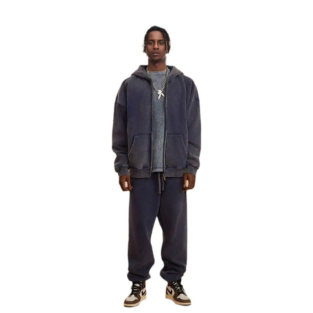 Man wearing a dark green hooded zip-up cardigan with a fleece lining and long sleeves.