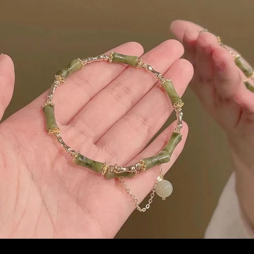 Women's bamboo bracelet with coloured glaze beads in plum wine colour featuring bamboo joint design