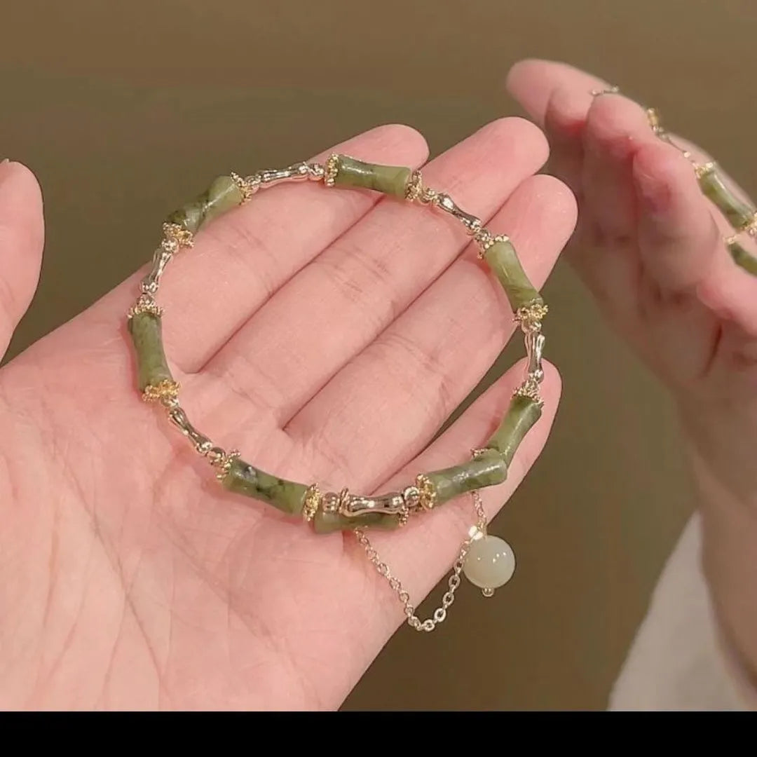 Women's bamboo bracelet with coloured glaze beads in plum wine colour featuring bamboo joint design