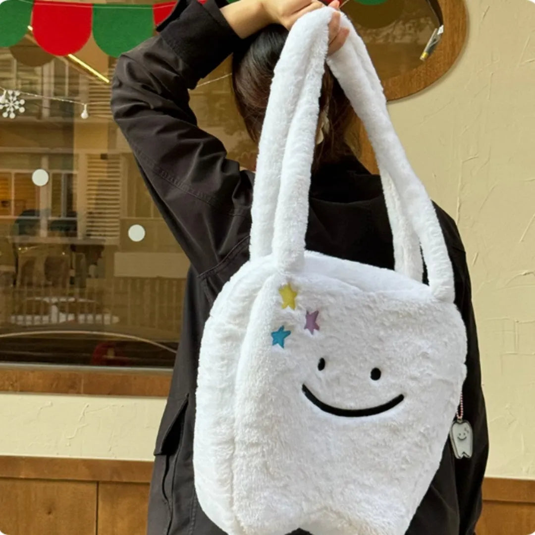 White plush shoulder tote bag with large tooth design and crossbody strap