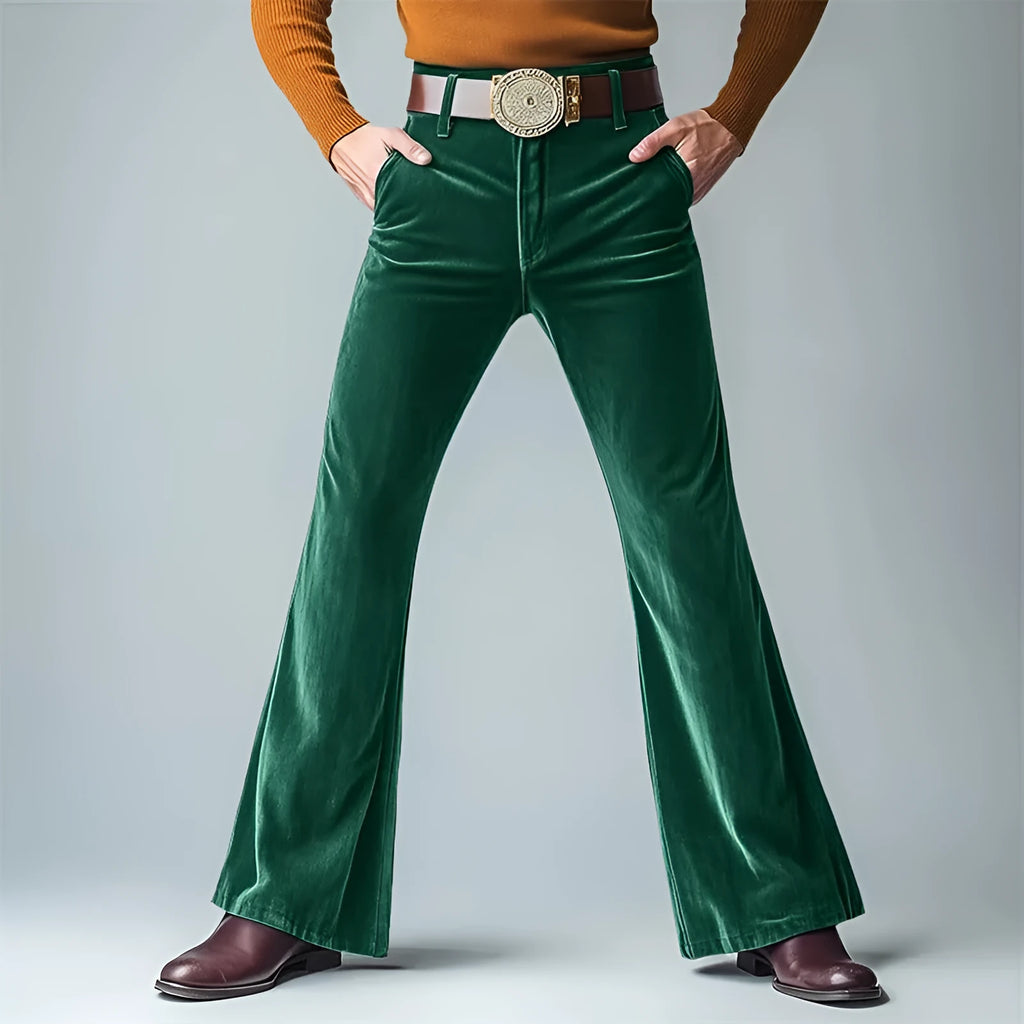 Man wearing slim flared velvet suit trousers in a dark colour for a banquet setting