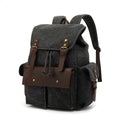 Retro canvas backpack in military green with antique bronze hardware, shown next to a 16-inch laptop.