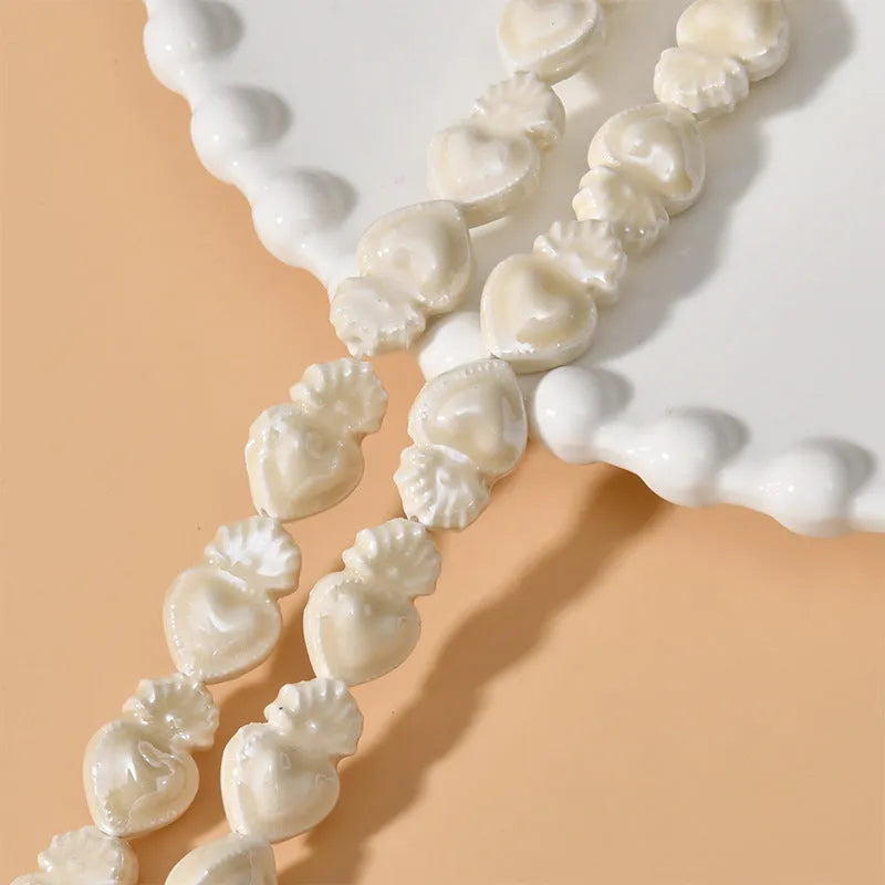 Love heart shaped torch ceramic beads in various colours including cream white, pinks, blues and greens for jewellery making