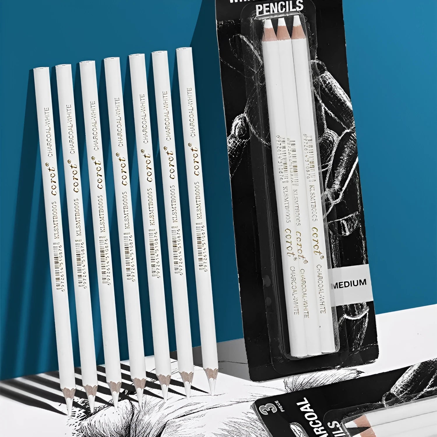 Three white charcoal drawing pencils with wooden barrels for sketching and highlighting